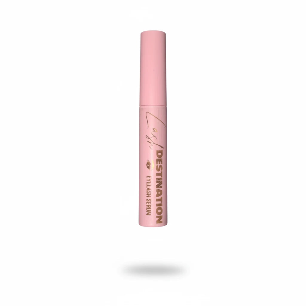 LashDestination eyelash serum in a light pink tube with gold lettering and a precision applicator brush