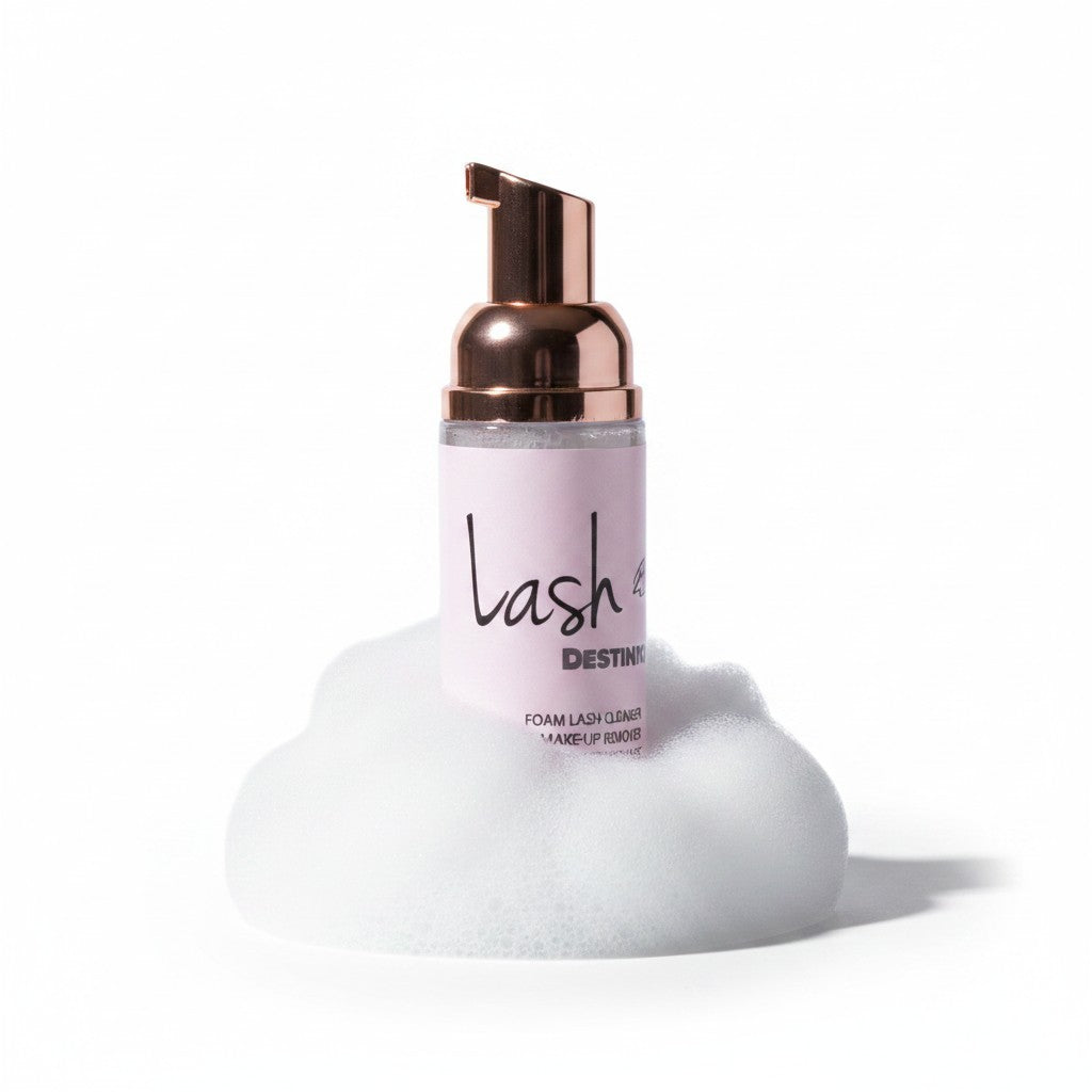 LashDestination gentle foam lash cleanser and makeup remover in a pump bottle surrounded by white cleansing foam